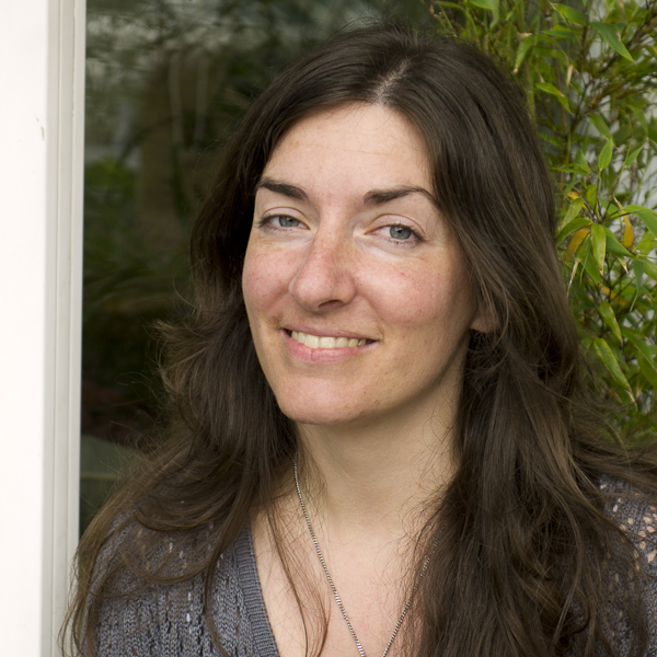 Dana Balassi sitting in front of Dragonfly Holistic Healing in Fremont, Seattle, Washington